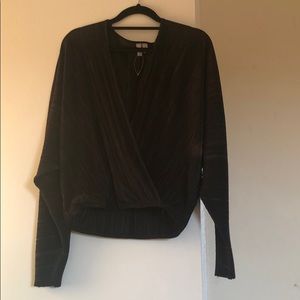 Tall wrap top in plisse with batwing sleeve.